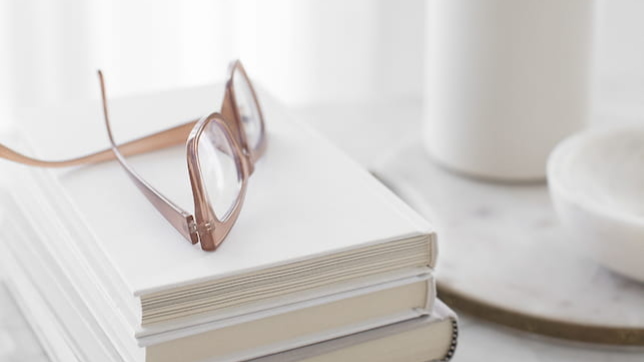 Books and reading glasses representing nutrition presentation resources