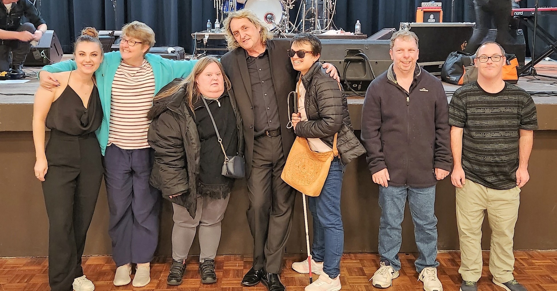 A group in front of the stage at the Whispering Jack show