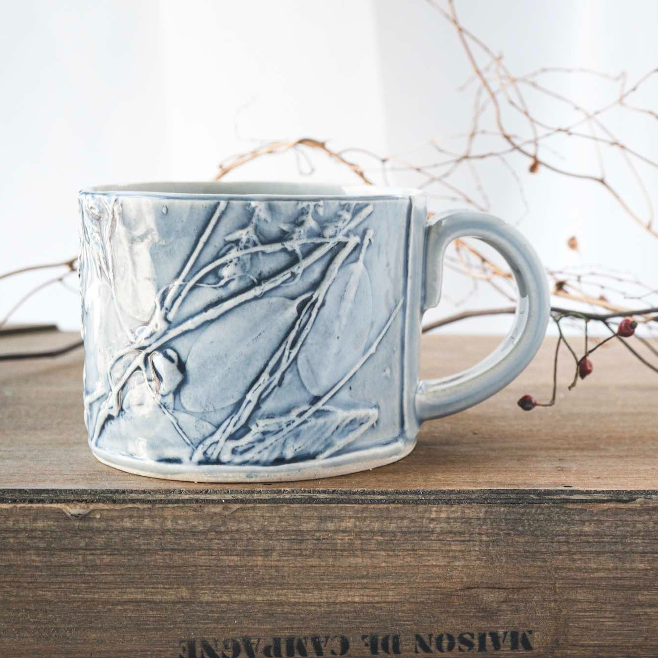 handmade ceramic mug with botanical relief textures