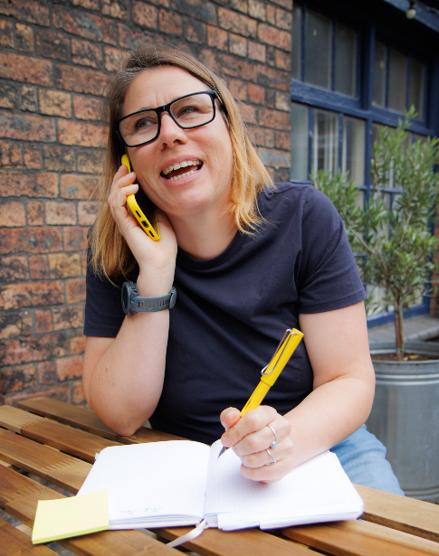 woman with brown hair on the phone - brand image