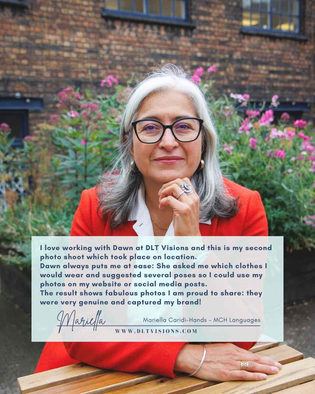 woman with grey hair and glasses wearing a red jacket - brand image