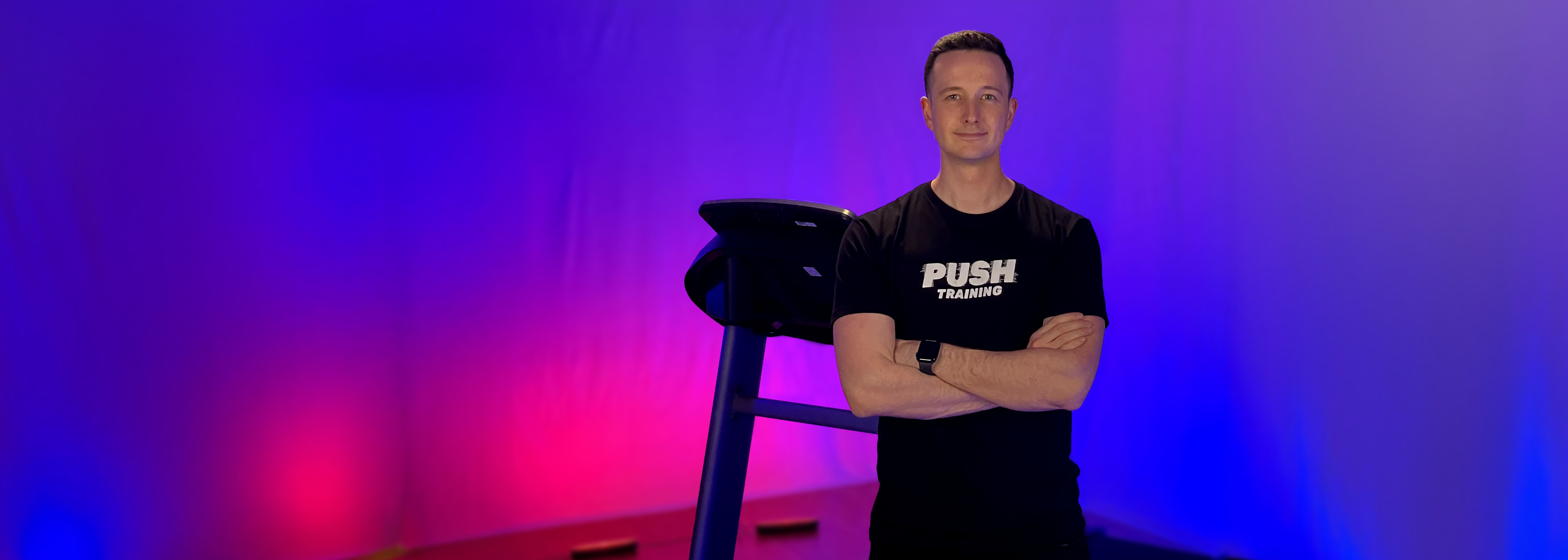 Jacob standing in front of a treadmill