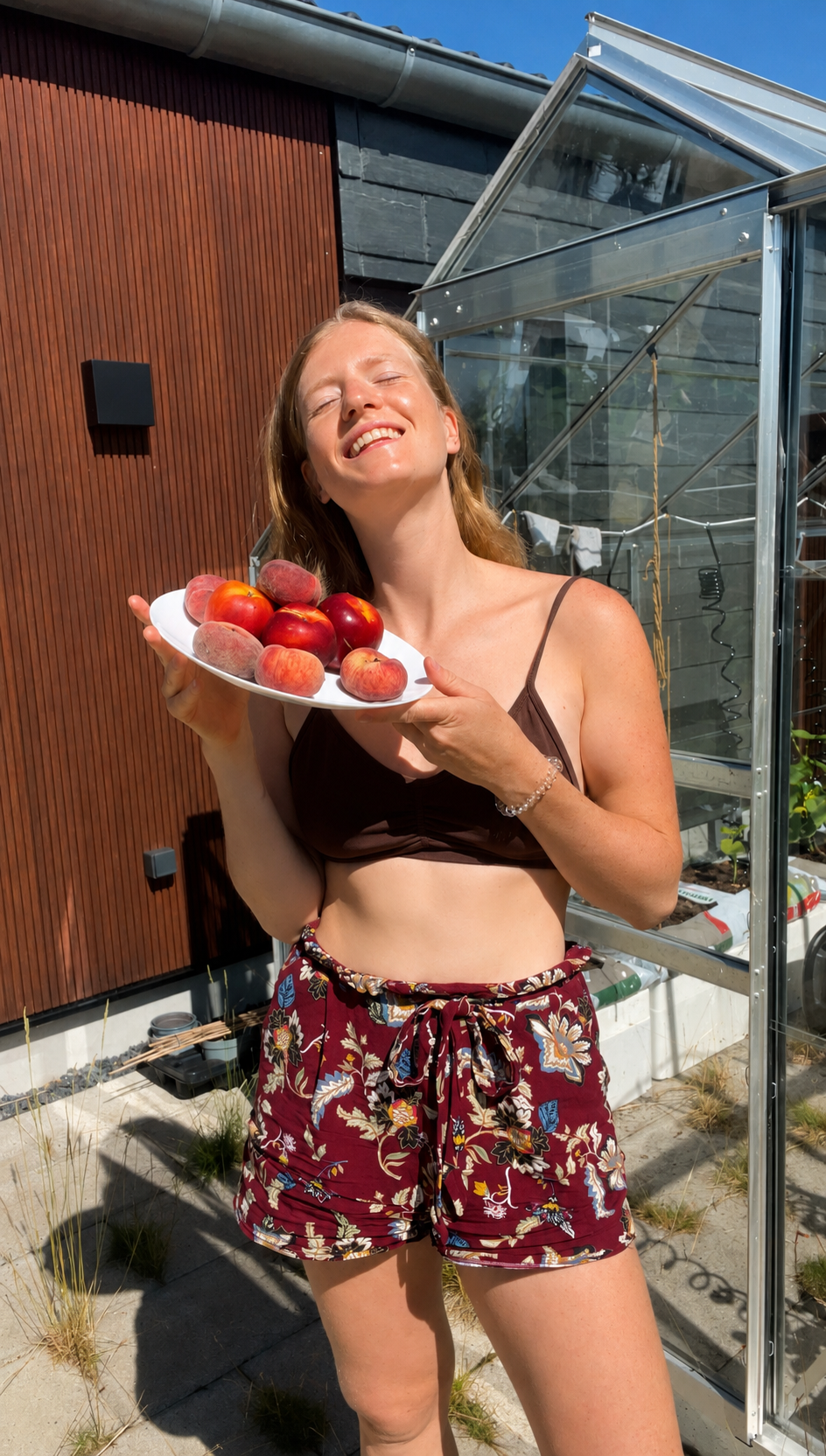 Julia Sana holding fresh fruit in the sun