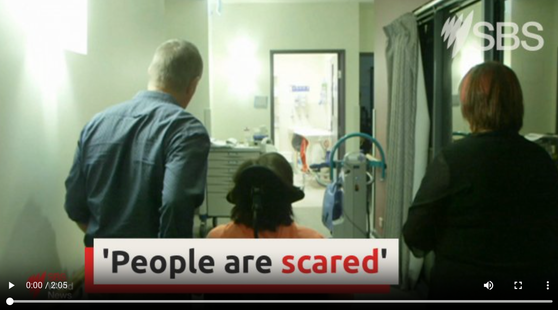 A screenshot of the SBS Video. It is a picture of a person in a wheelchair from the back, with the text 'people are scared' over the image. the word scared is highlighted in red