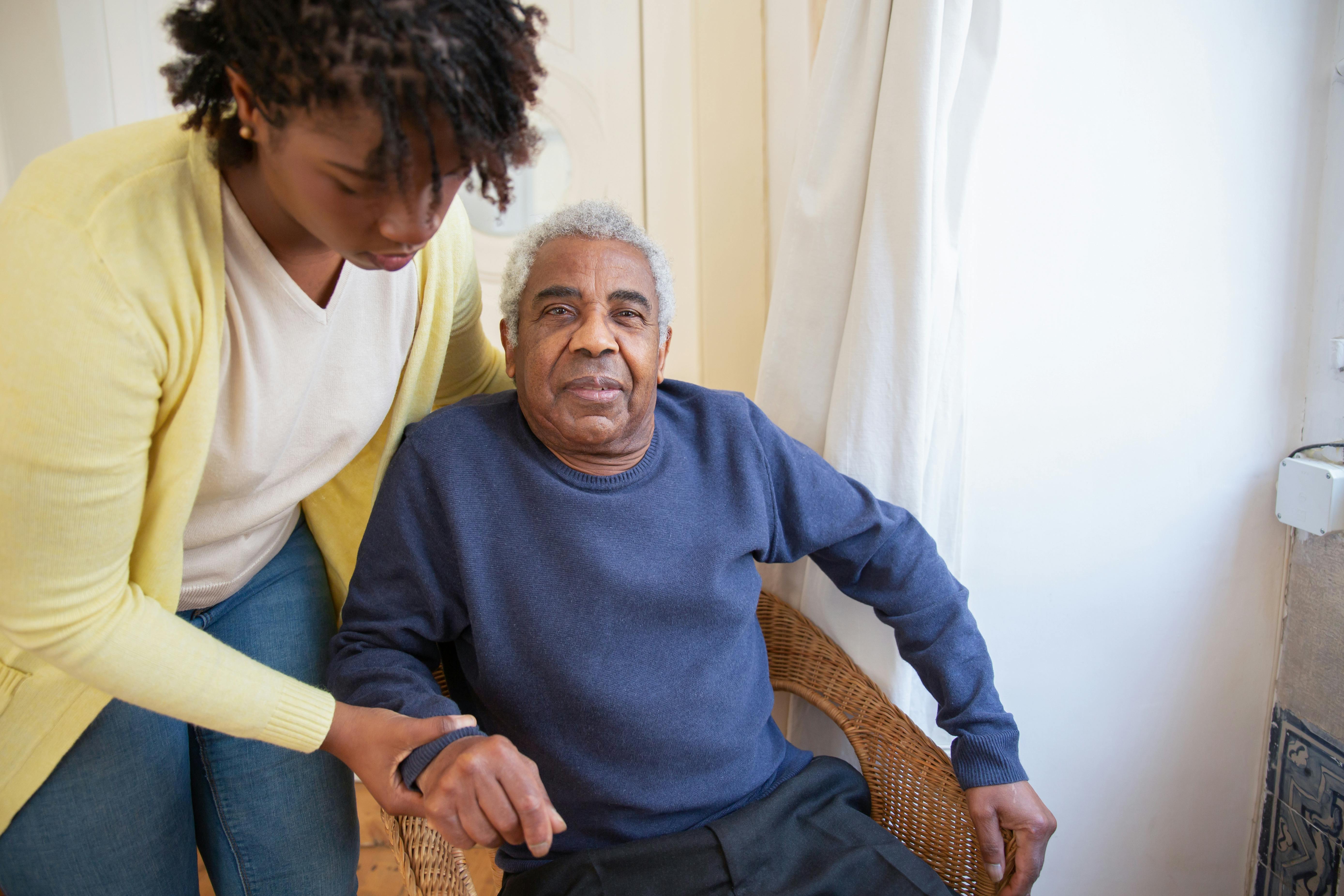 Caregiver helping older adult to feel comfortable.