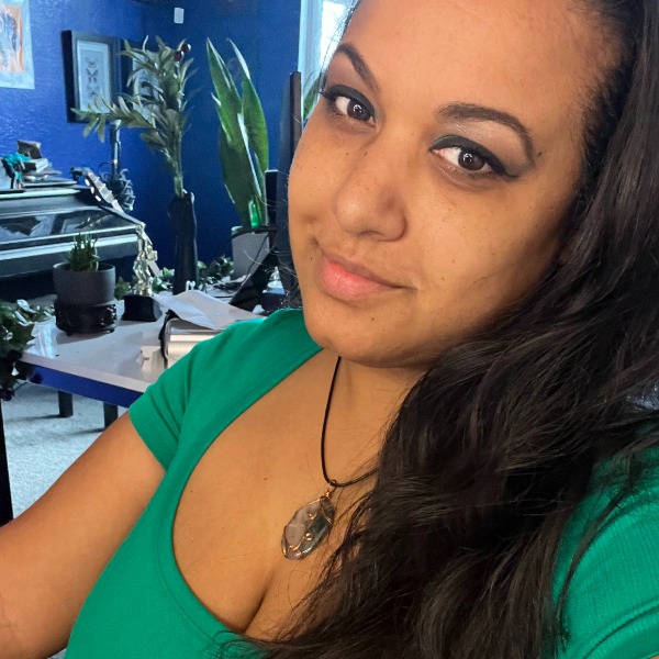 Photograph of a woman with a blue room in the background