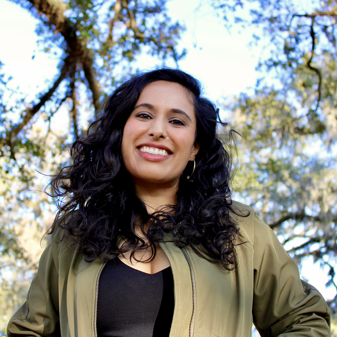 Photograph of a woman with trees in the background