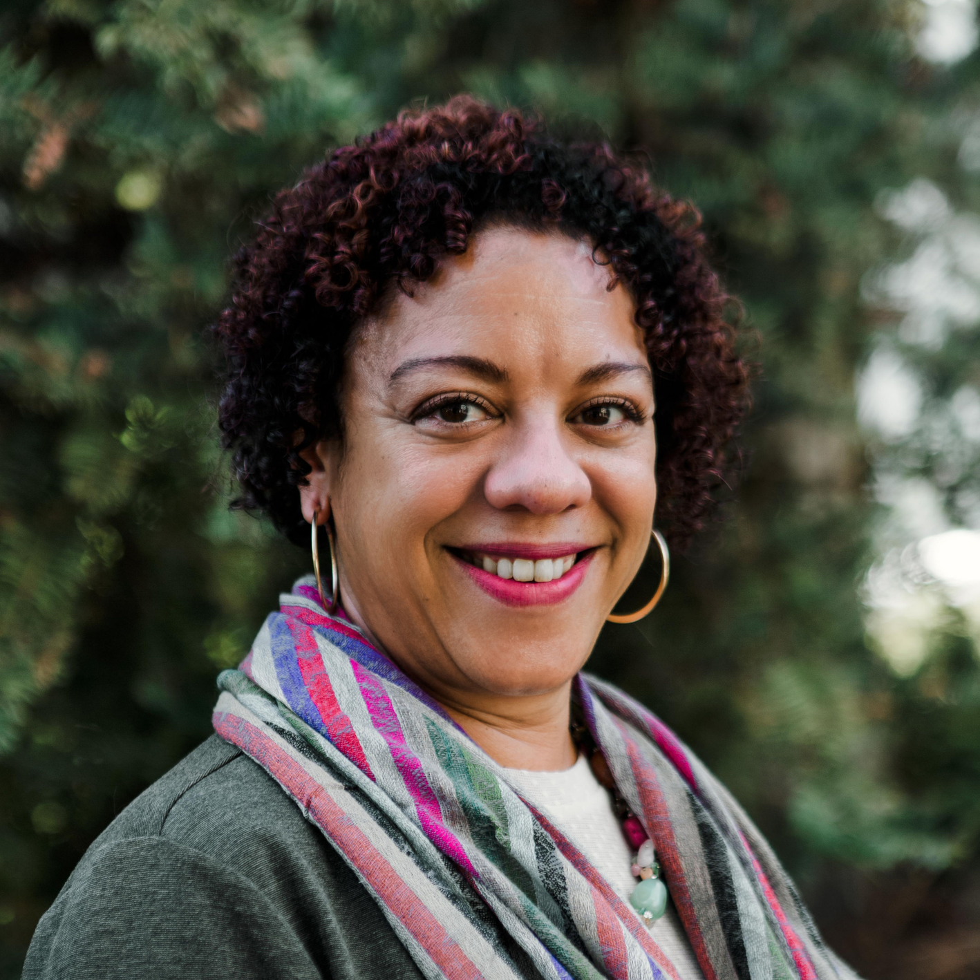 A woman with some trees in the background