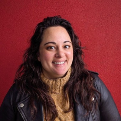 Photograph of a woman in front of a red wall