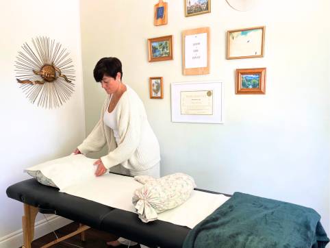reiki master amy setting up the reiki treatment room in purley, london