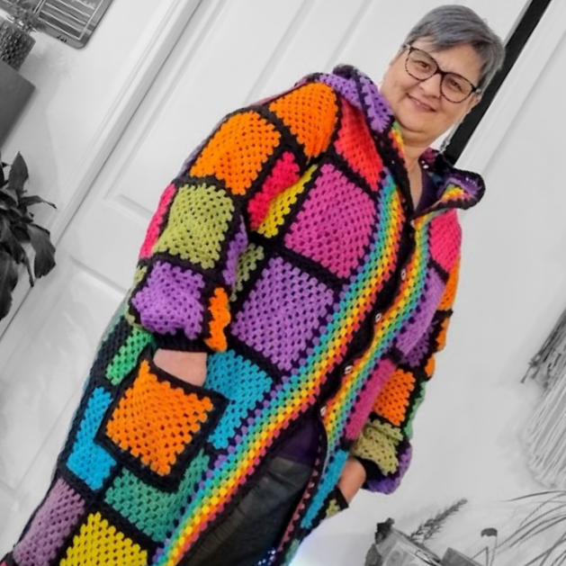 Fi Hocking wearing a handmade rainbow granny square crochet coat