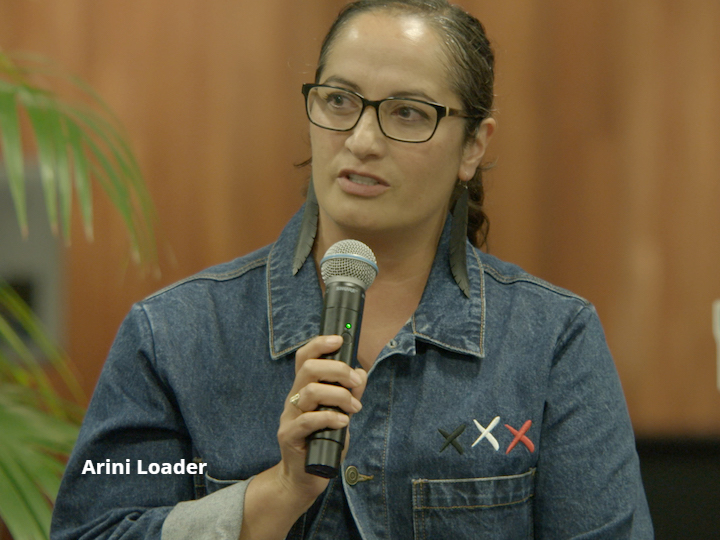 Head and shoulder photo of Arini Loader, participating in panel discussion.