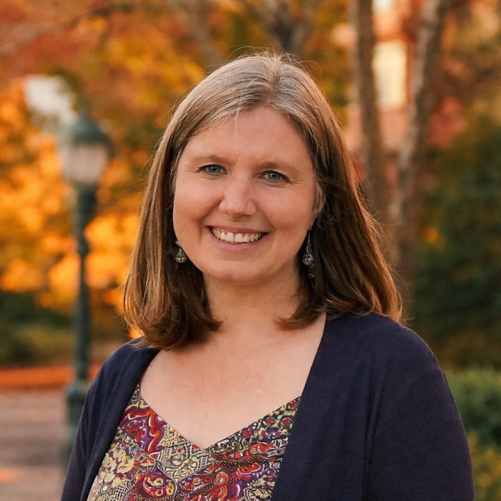 Headshot of smiling woman with shoulder-length hair