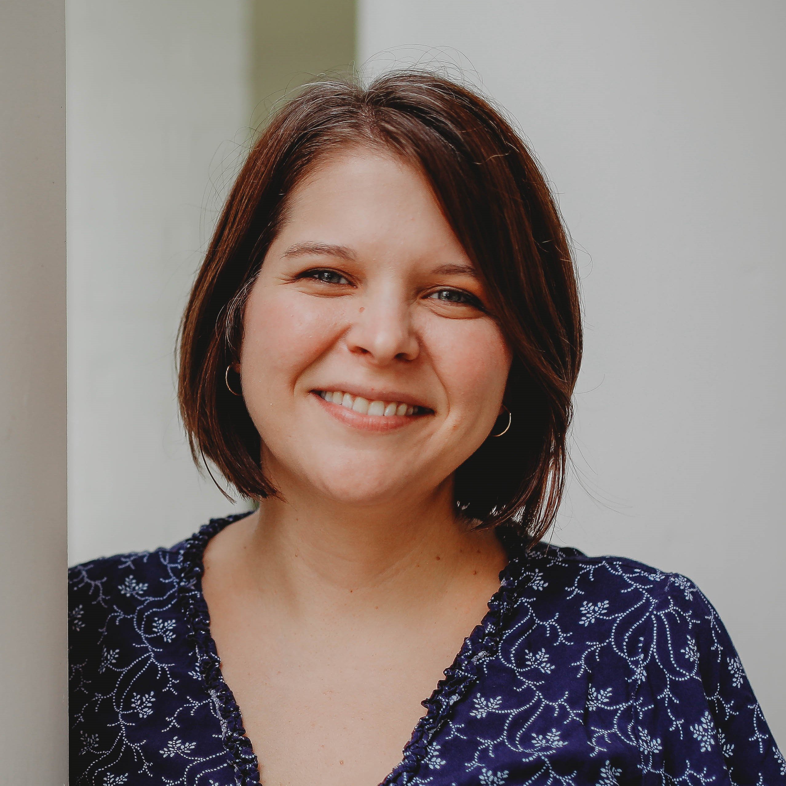 Headshot of woman in blue dress