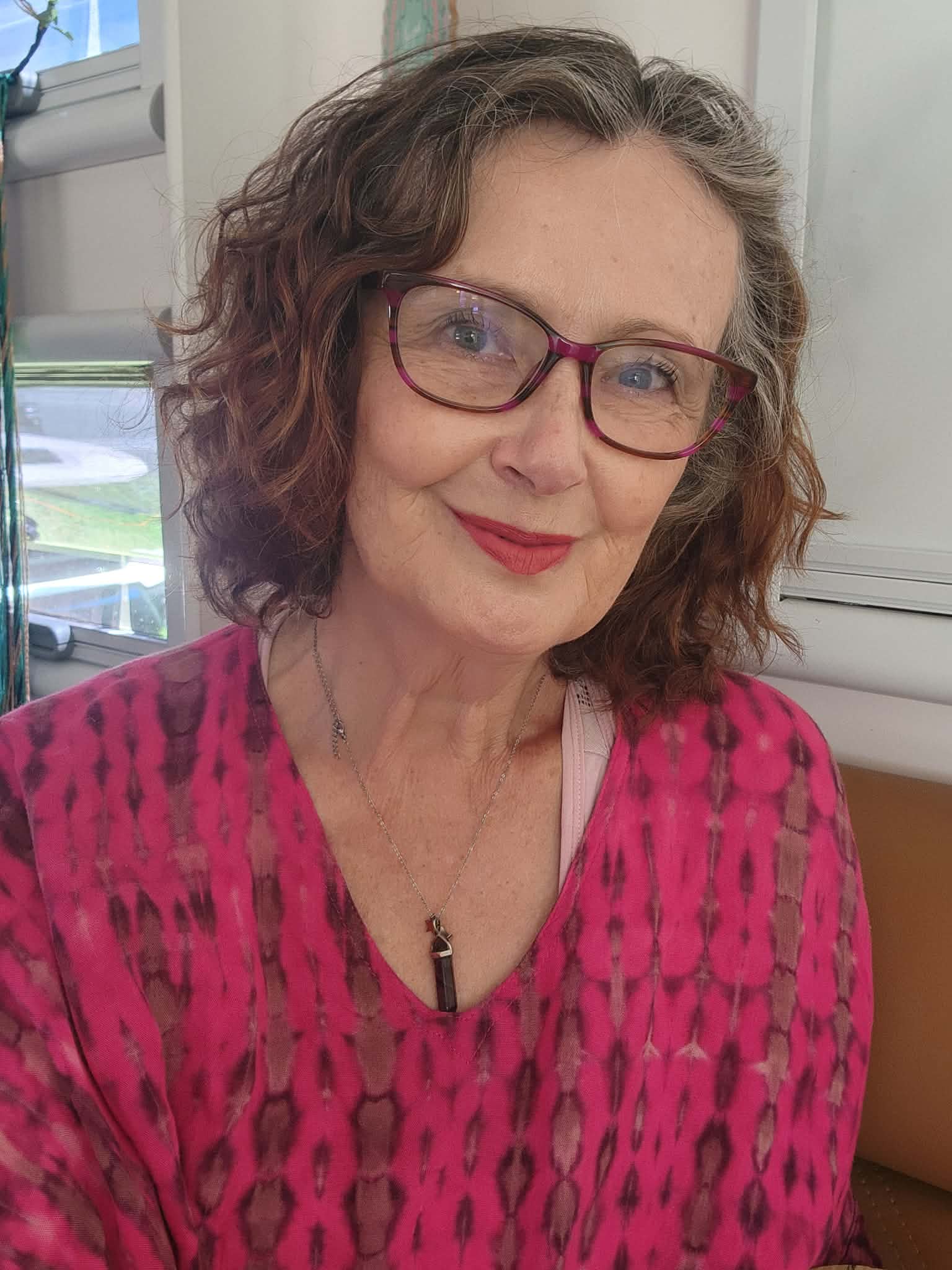 Karen in pink, smiling warmly
