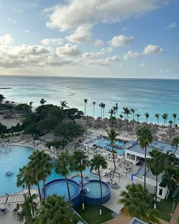 Luxury all-inclusive resort suite with private balcony and ocean view.