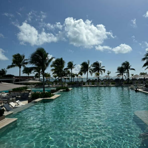 Couple relaxing at an all-inclusive resort pool.