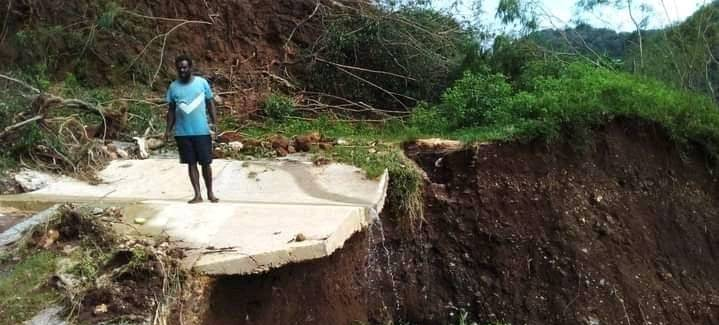 A photo of a man standing on a road near Williams Bay, Erromango that was destroyed by flooding during the 2020 La Niña event