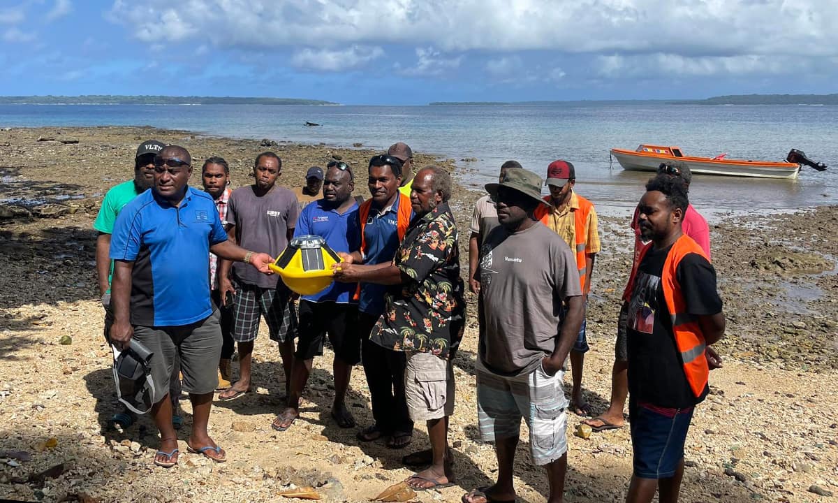 Community members, Department of Fisheries staff and VanKIRAP staff pose with a Sofar Spotter ocean climate monitoring buoy prior to launch at Million Dollar Point, Espiritu Santo