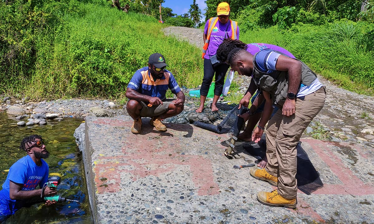 Public Works Department staff and VanKIRAP Infrastructure coordinator Raviky Talae working installing a water level monitor in south Santo