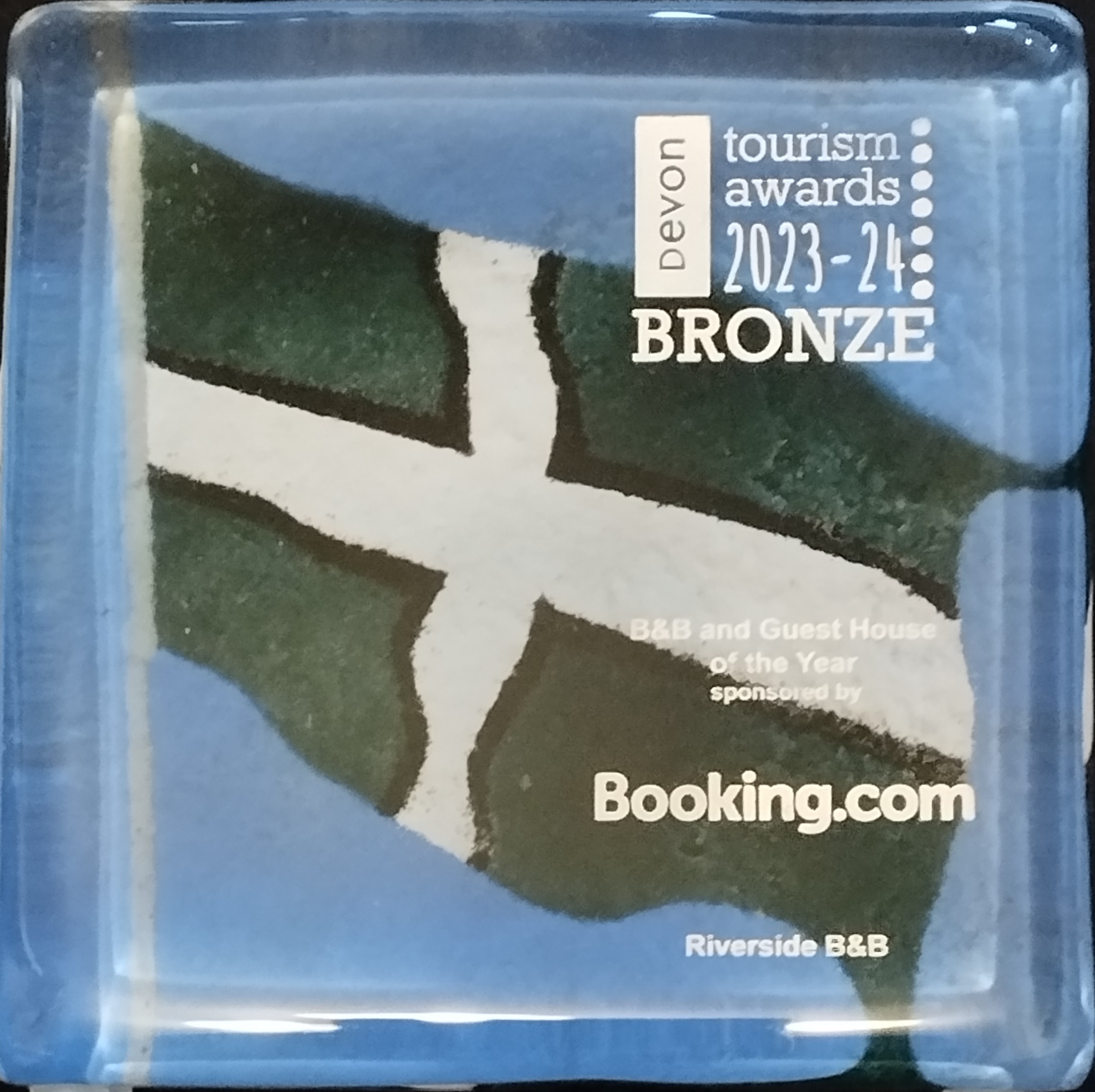 Devon Tourism Award B&B and Guest House of the Year Bronze Award for Riverside B&B.  The award is in glass and consists of a Devon Flag painted onto blue glass