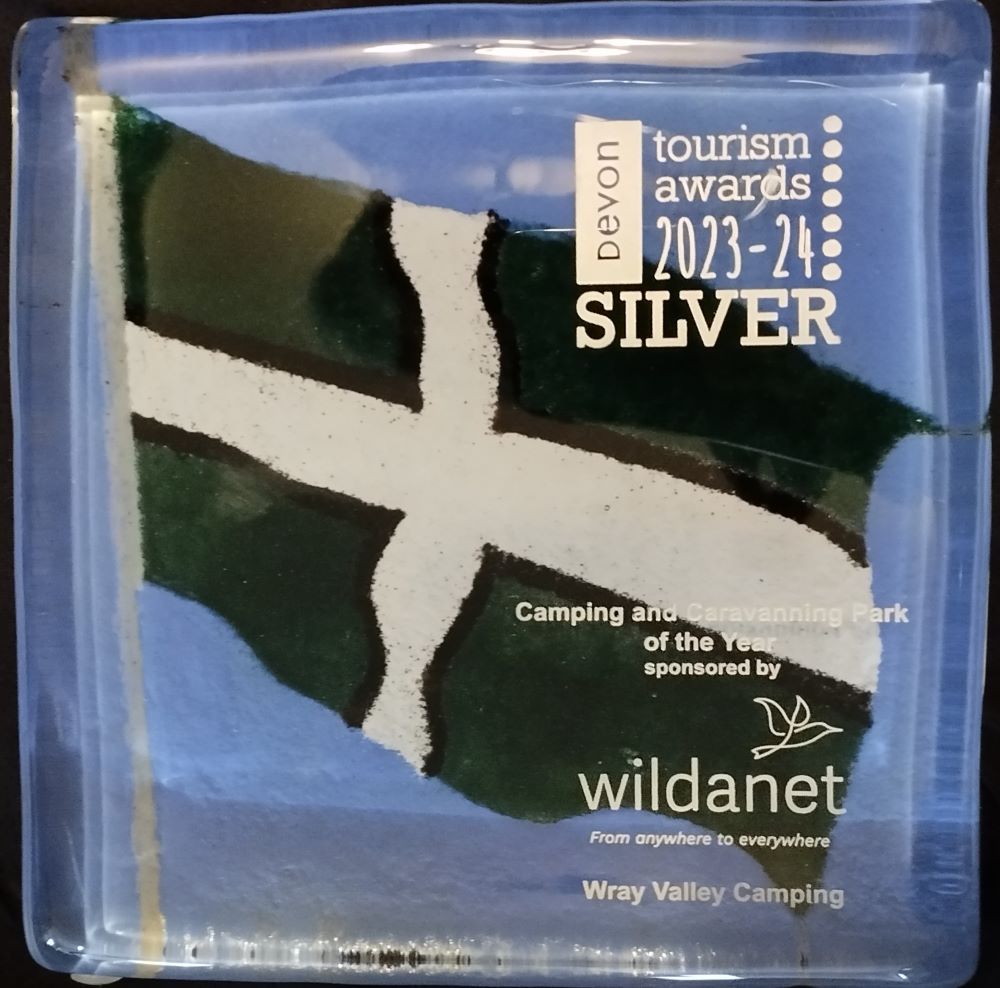 Devon Tourism Awards Camping and Caravanning Park of the Year Silver Award for Wray Valley Camping  The award is in glass and consists of a Devon Flag painted onto blue glass