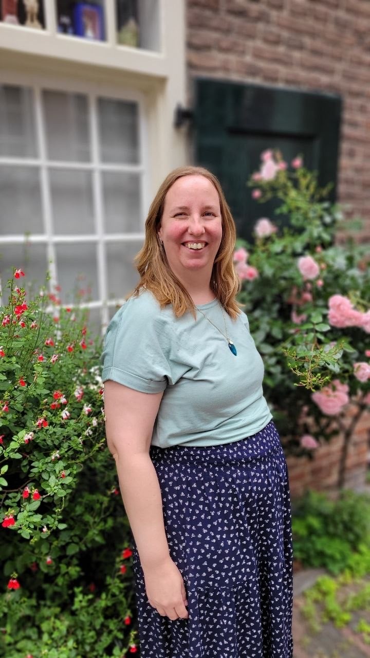 Henrike Dijkstra, eigenaar van Pencils & Stories, bij een mooi oud huisje