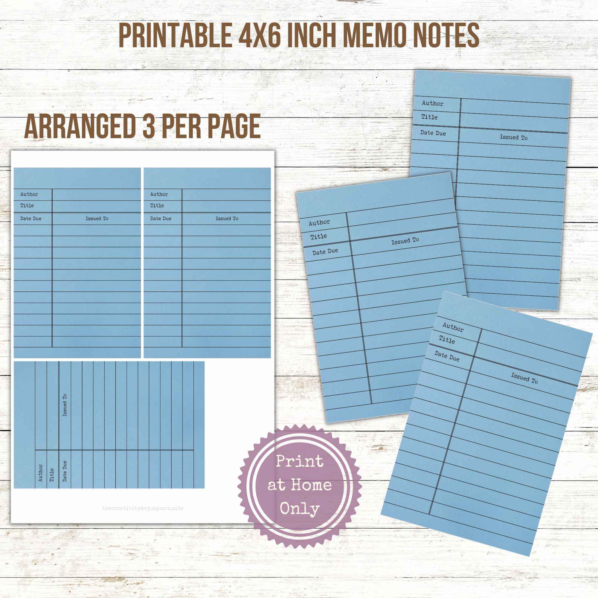 three blue library card memo notes arranged on a single sheet of paper next to cut out memo notes on a wooden desktop