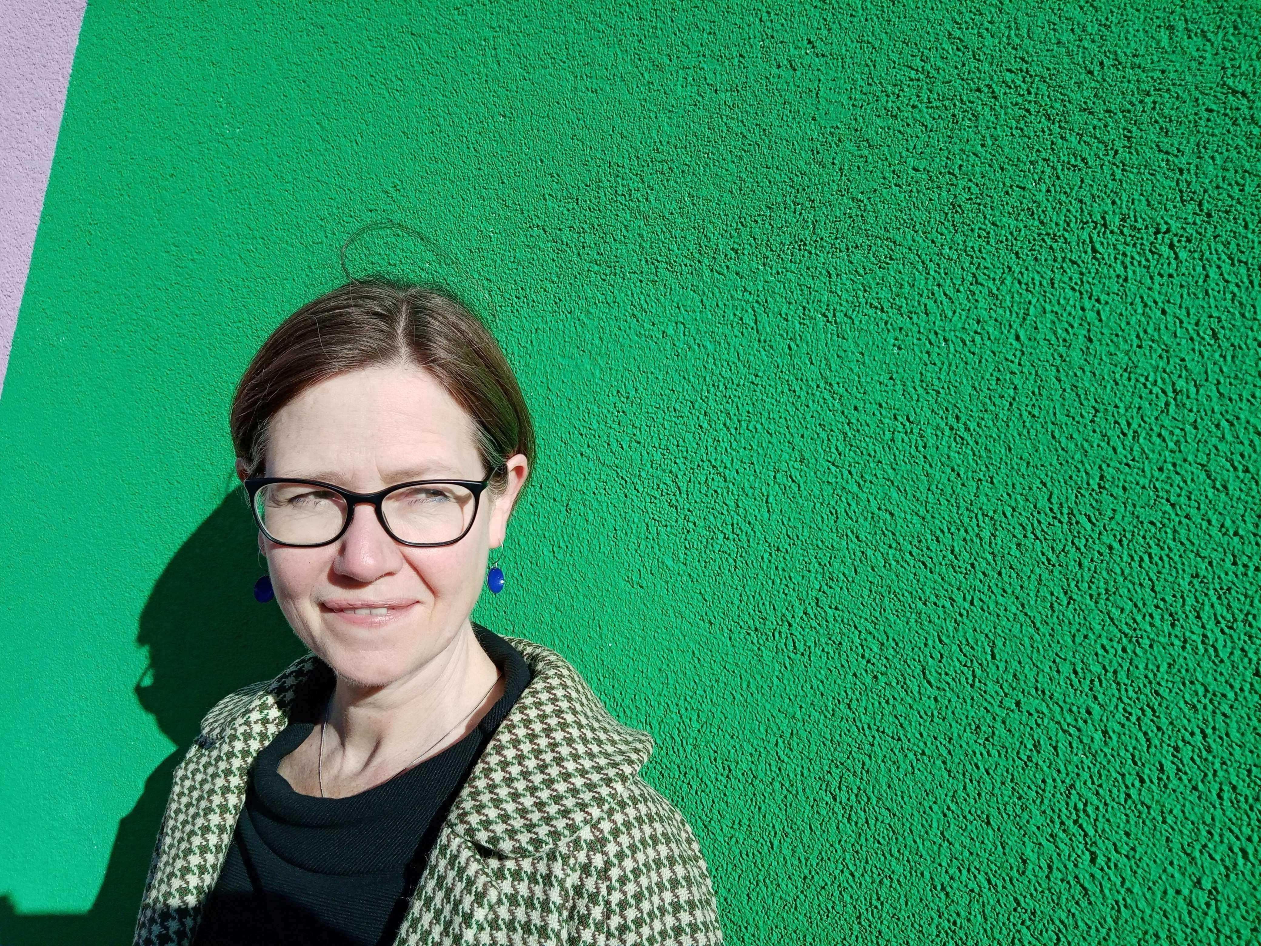 image of Julie in bright green background