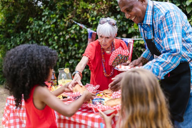 Picture of a multi-cultural family enjoying each others' company in an outdoor setting, over food and family-friendly fun, presented in the Near Me Discovery Things To Do content hub as the blog post image for Family Friendly Attractions Near Panama City Beach, FL