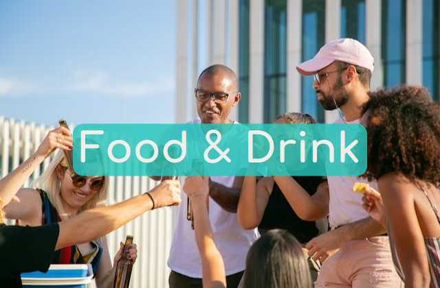 A multi-cultural group of people standing with drinks and food in hand celebrating and having fun, presented as the image for the Near Me Discovery blog content hub image for Food and Drink articles and posts, including best restaurants near me, best bars near me, best food to try near me, and best drinks near me