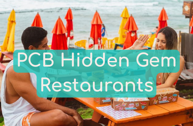 Picture of a man and woman sitting down to eat while laughing and having a great time at a restaurant that is beachside with a view of the beach waves in the image background, used as the blog post image for the article about the hidden gem restaurants loved by locals in Panama City Beach, FL for Near Me Discovery, local search and local discovery blog and advertising