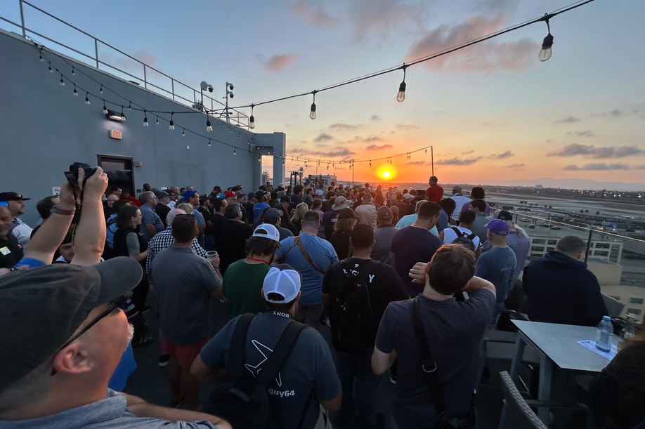 At sunset, a group of people gathered for a rooftop viewing party.