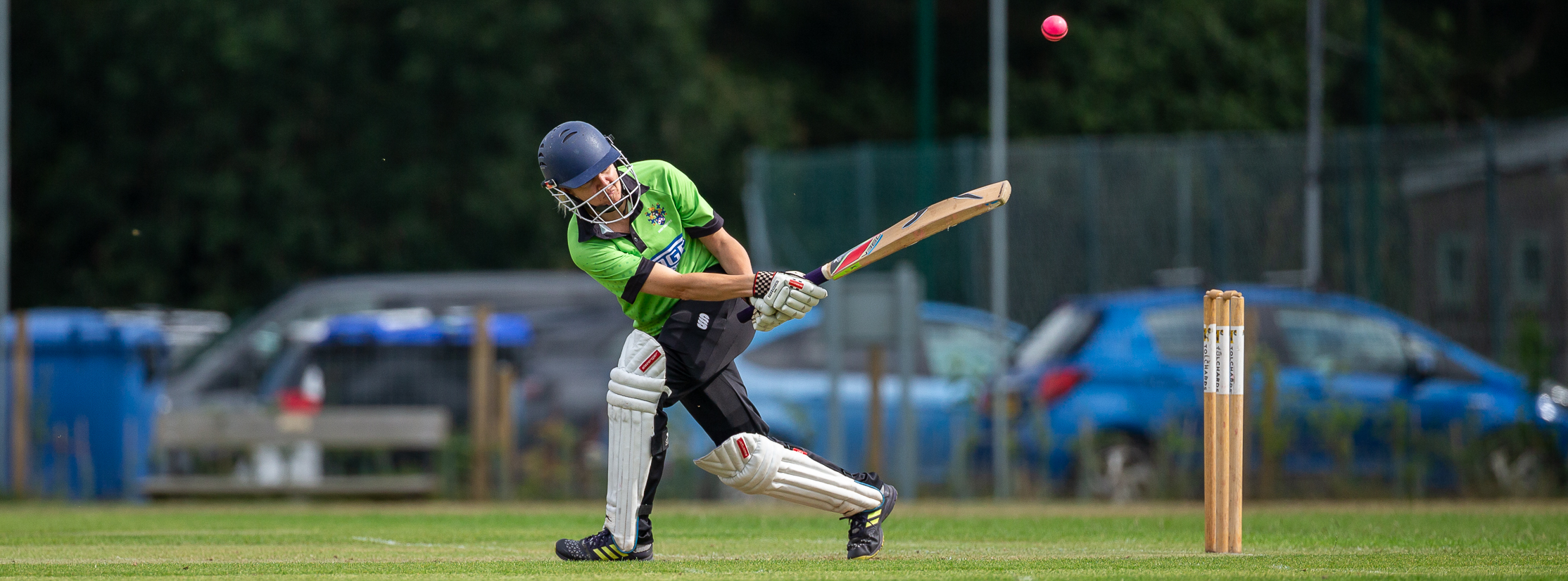 Women batter hitting a ball behind the stumps