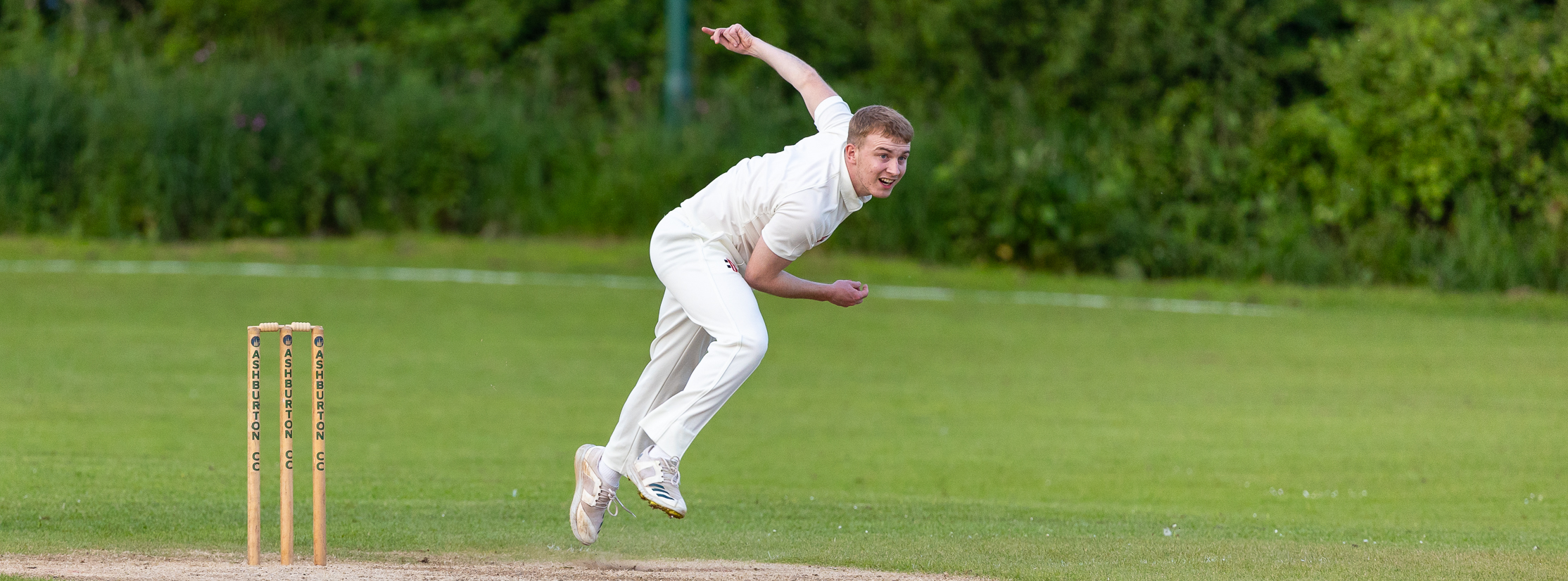 Mens fast bowler at the end of his action