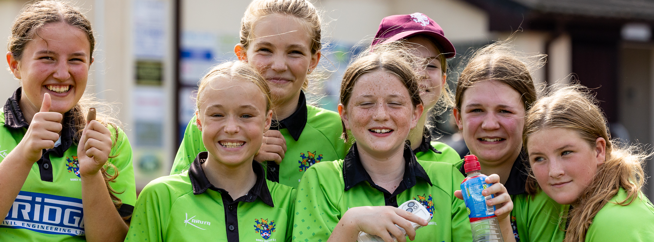 Group of happy girls cricketers after a match