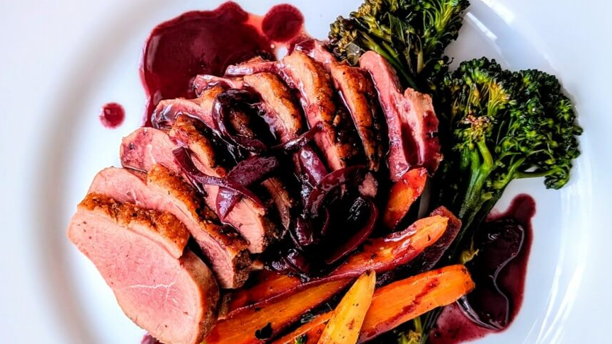 Duck breast with red wine pan sauce and vegetables