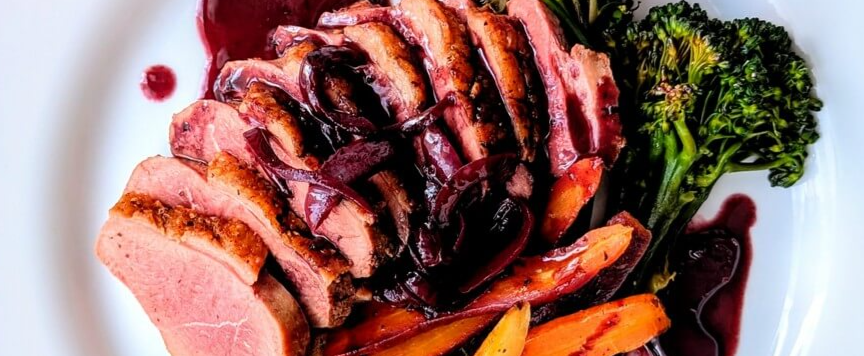 Duck breast with red wine pan sauce and vegetables