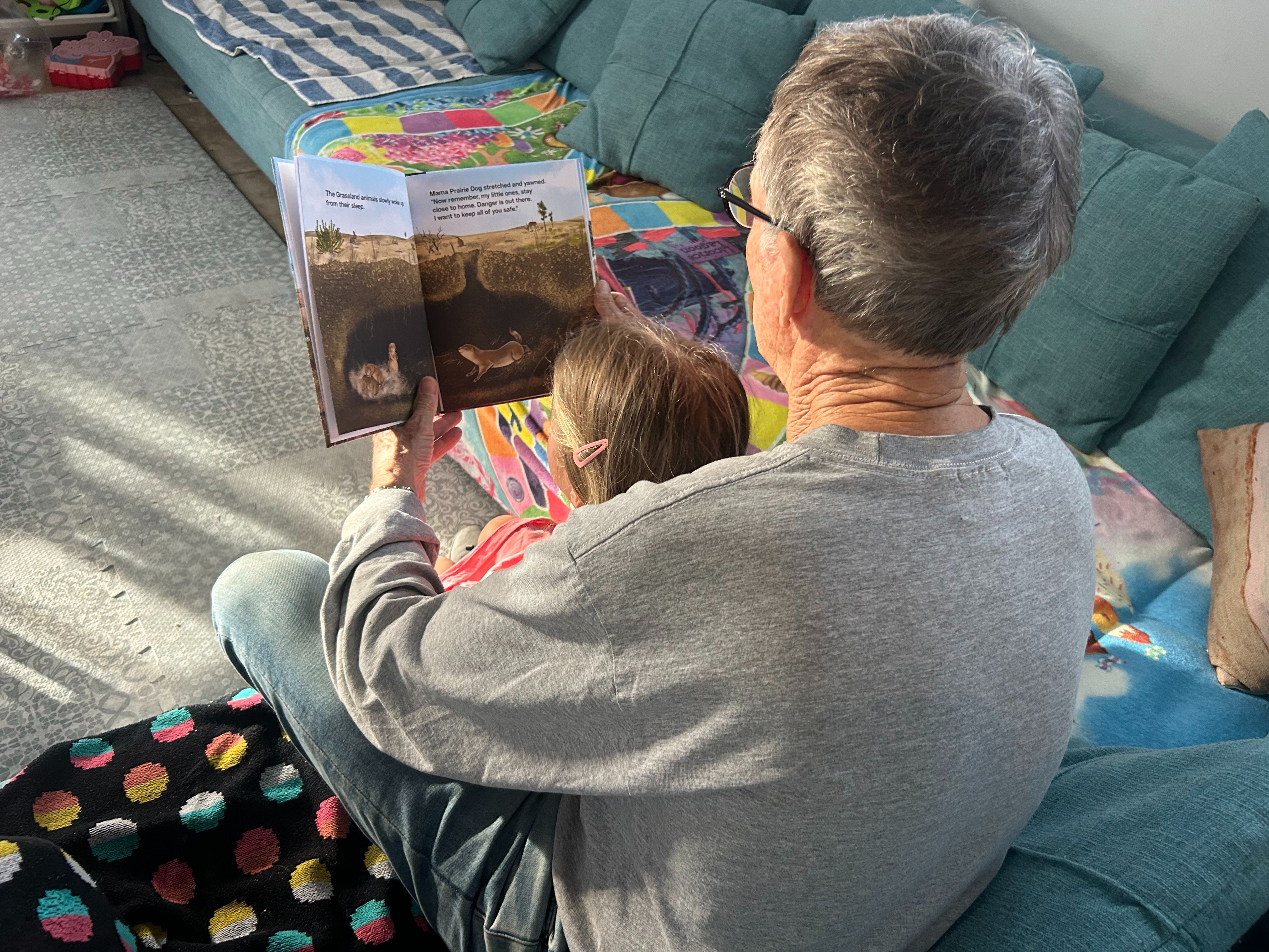 A dad reading a book to his daughter