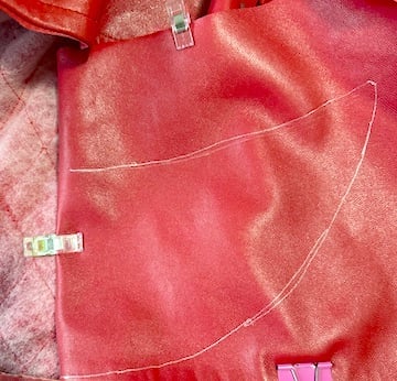 Hands, fabric and a sewing machine