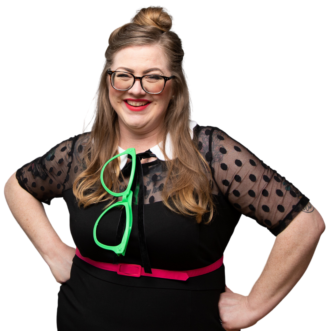 Maggie is shown with her hands on her hips, wearing a secondhand dress and custom-made removable collar. A pair of oversized green glasses is tucked into the collar of her dress.