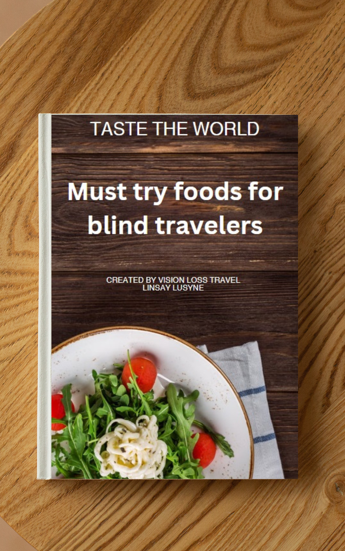 A photo of the E-book cover. Taste the world: Must try foods for blind travelers. It shows a plate with pasta, rucola and tomato on the cover.