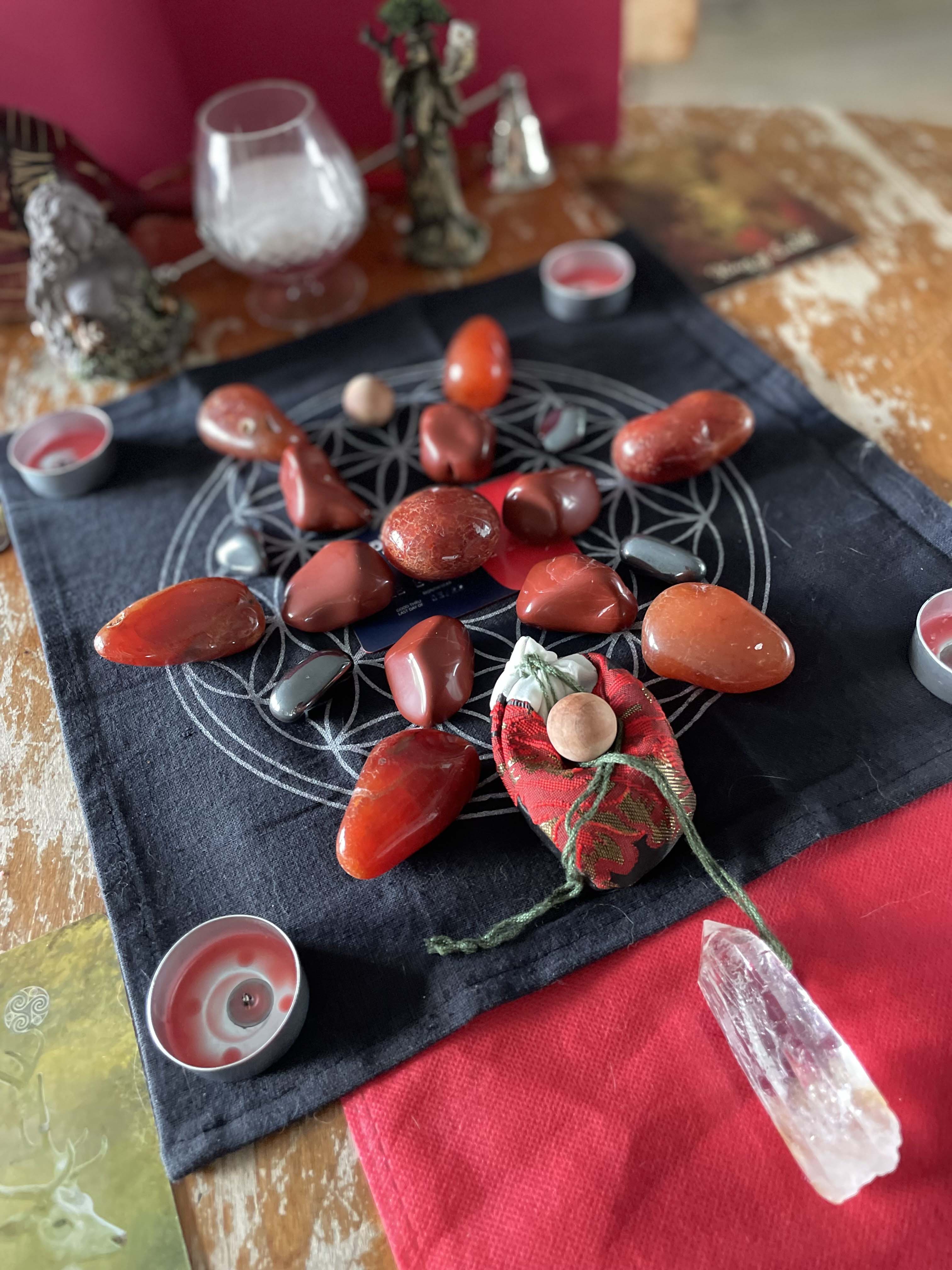 A crystal grid is set up for a root chakra balancing emersion session