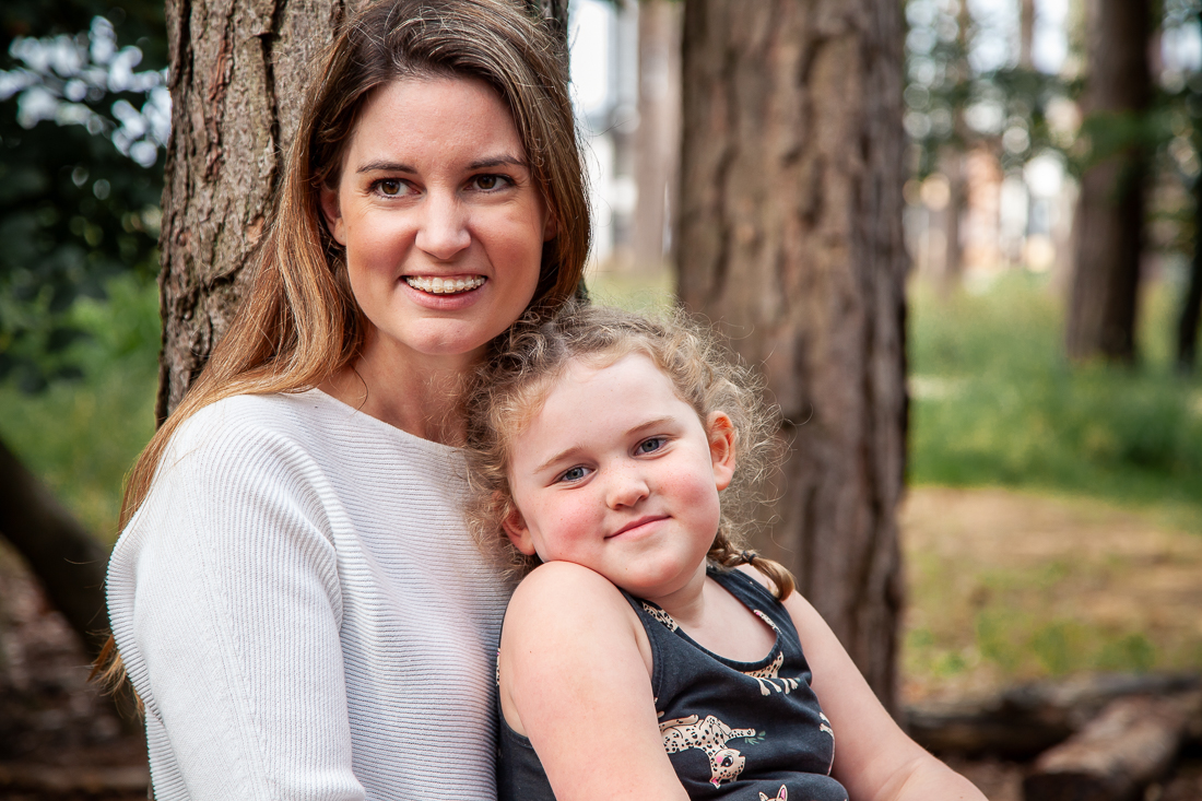 An autumn photograph of a mother an daughter in the woods. Family mini sessions in Hampshire.