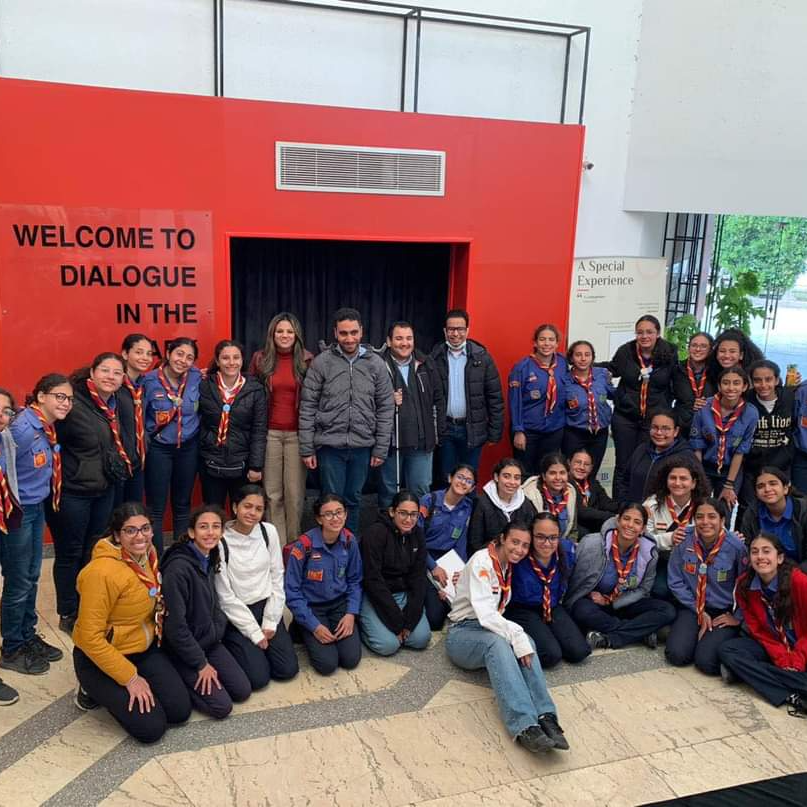 Photo of visitors and guides at Dialogue in the Dark in Cairo in front of the entrance to the black box.
