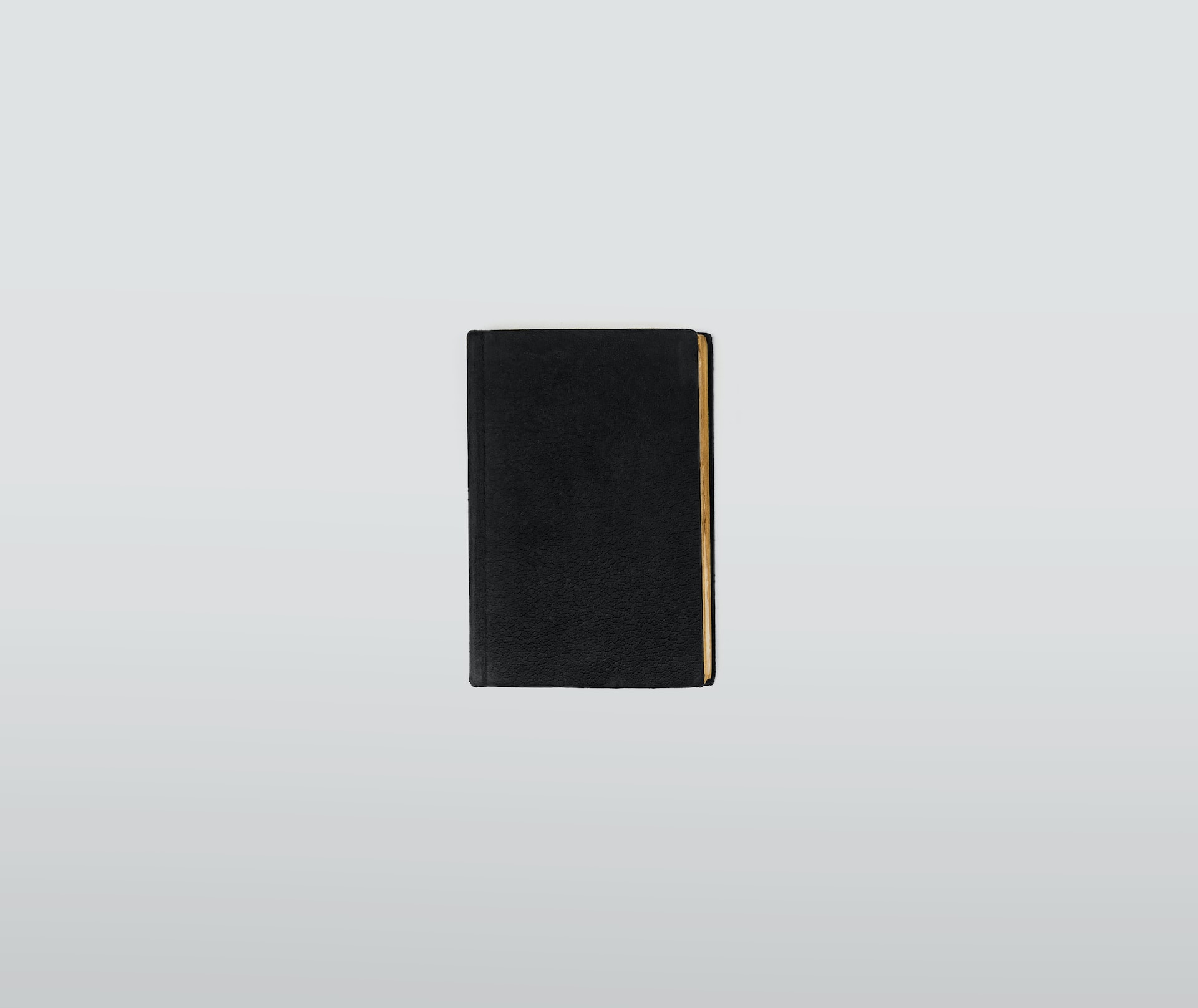 A black notepad, closed