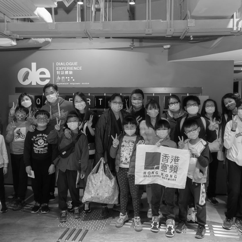 Foto of a the hong kong crew with children visiting their site